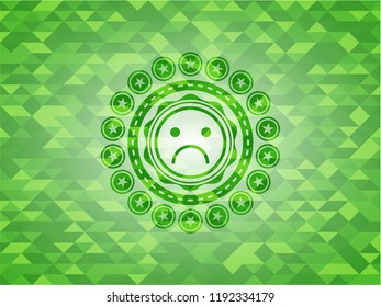 sad face icon inside green emblem with mosaic ecological style background