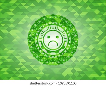 sad face icon inside green emblem with mosaic background