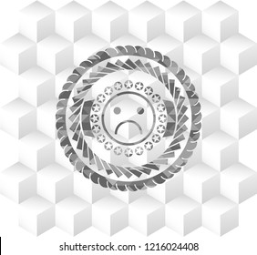 sad face icon inside grey emblem with cube white background