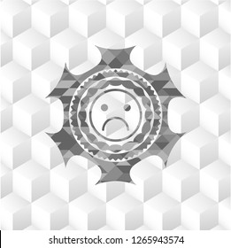 sad face icon inside grey badge with geometric cube white background