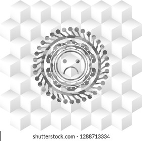 sad face icon inside grey icon or emblem with geometric cube white background