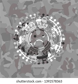 sad face icon inside grey camo texture