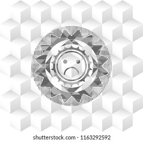 sad face icon inside realistic grey emblem with geometric cube white background