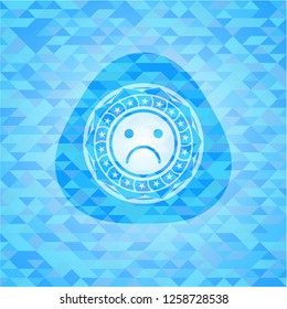sad face icon inside realistic light blue mosaic emblem