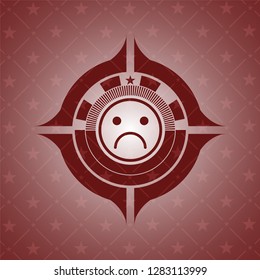 sad face icon inside realistic red emblem