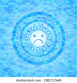 sad face icon inside realistic light blue mosaic emblem
