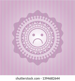 sad face icon inside realistic pink emblem