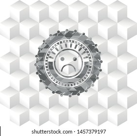 sad face icon inside realistic grey emblem with cube white background