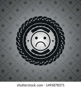 sad face icon inside realistic black emblem
