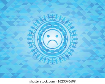 sad face icon inside realistic light blue mosaic emblem