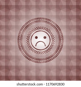 sad face icon inside red badge with geometric pattern. Seamless.