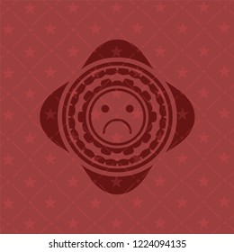 sad face icon inside red icon or emblem