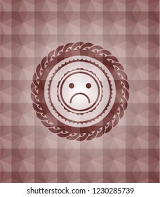 sad face icon inside red emblem with geometric pattern background. Seamless.