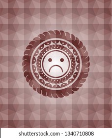 sad face icon inside red emblem with geometric pattern background. Seamless.