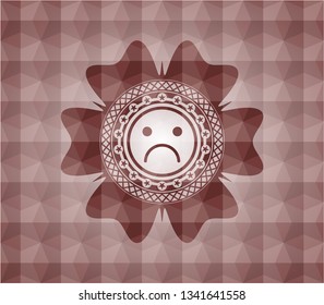 sad face icon inside red seamless polygonal badge.