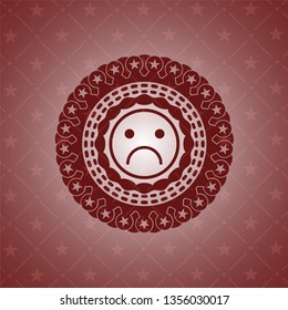 sad face icon inside red emblem