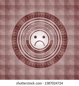 sad face icon inside red geometric pattern emblem. Seamless.