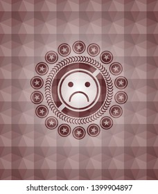 sad face icon inside red emblem or badge with abstract geometric polygonal pattern background. Seamless.