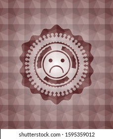 sad face icon inside red seamless emblem with geometric pattern background.