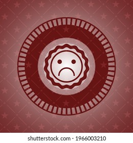 sad face icon inside red emblem. 