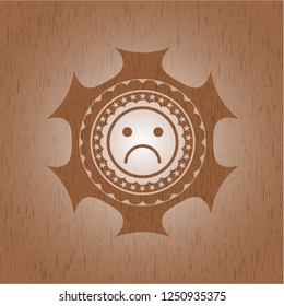 sad face icon inside retro wooden emblem