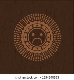 sad face icon inside retro wooden emblem