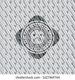sad face icon inside shiny silver emblem. Scales pattern. Vector Illustration. Detailed.