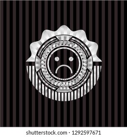 sad face icon inside silver badge