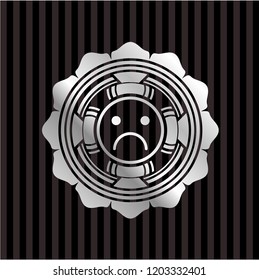 sad face icon inside silvery shiny emblem