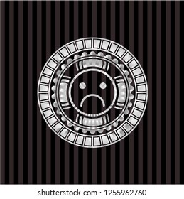 sad face icon inside silvery emblem