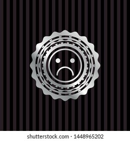 sad face icon inside silvery badge