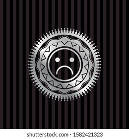 sad face icon inside silvery emblem
