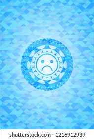 sad face icon inside sky blue emblem with triangle mosaic background