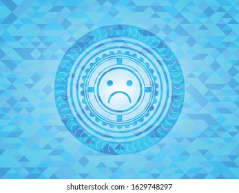 sad face icon inside sky blue emblem with triangle mosaic background