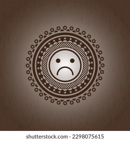 sad face icon inside wooden emblem. Vintage. 