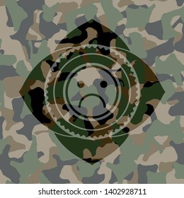 sad face icon on camo pattern