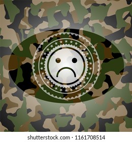 sad face icon on camouflage pattern