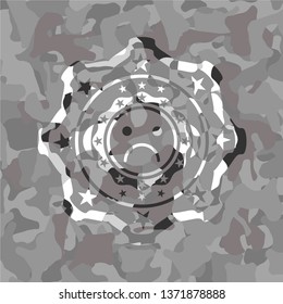 sad face icon on grey camo pattern