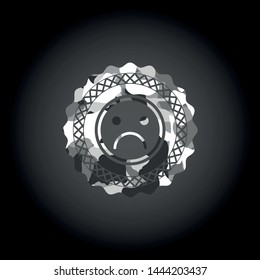 sad face icon on grey camo texture