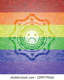 sad face icon on mosaic background with the colors of the LGBT flag