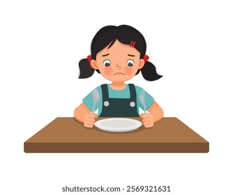 Sad little girl feel hungry looking at empty plate