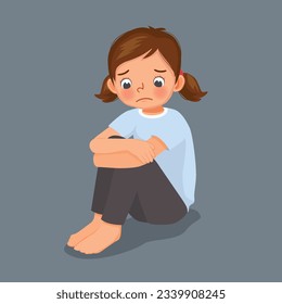 Sad lonely little girl sitting with hands holding her knee