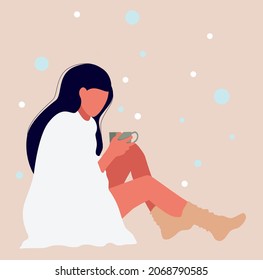 A sad and lonely teenage girl is sitting on the floor and has her head down. A girl with a mug of tea in her hands.