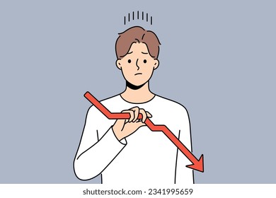 Sad man holds declining chart symbolizing beginning of crisis and financial recession affecting income. Upset guy with red down arrow reports decrease in number of clients or decrease in wages