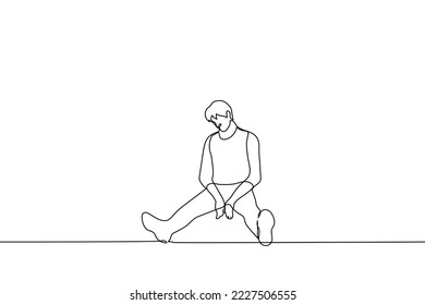 sad man sits on the floor with his head down and legs wide apart - one line drawing vector. concept of sadness, apathy, depression, loss, depression, loneliness