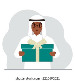 A Sad Muslim Man Holds A Large Gift Box With A Bow In His Hands. Vector Flat Illustration