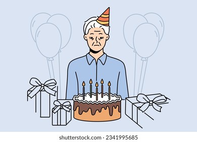 Sad old birthday person celebrating alone standing near table with gifts and cake and needing support of friends. Frustrated grandfather is sad because there are no guests for birthday parties