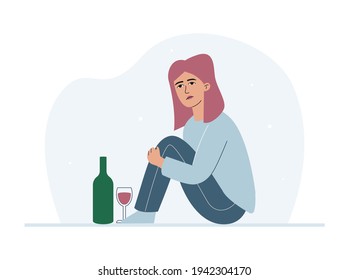 Sad teen girl with a bottle of wine and a glass. A young woman and alcohol.