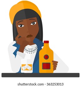 Sad woman with bottle and glass.