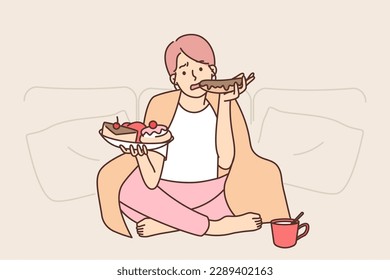 Sad woman eats lot of sweet high-calorie food wanting to get rid of stress after failed relationship. Girl with blanket on shoulders suffers from overeating associated with stress and loneliness